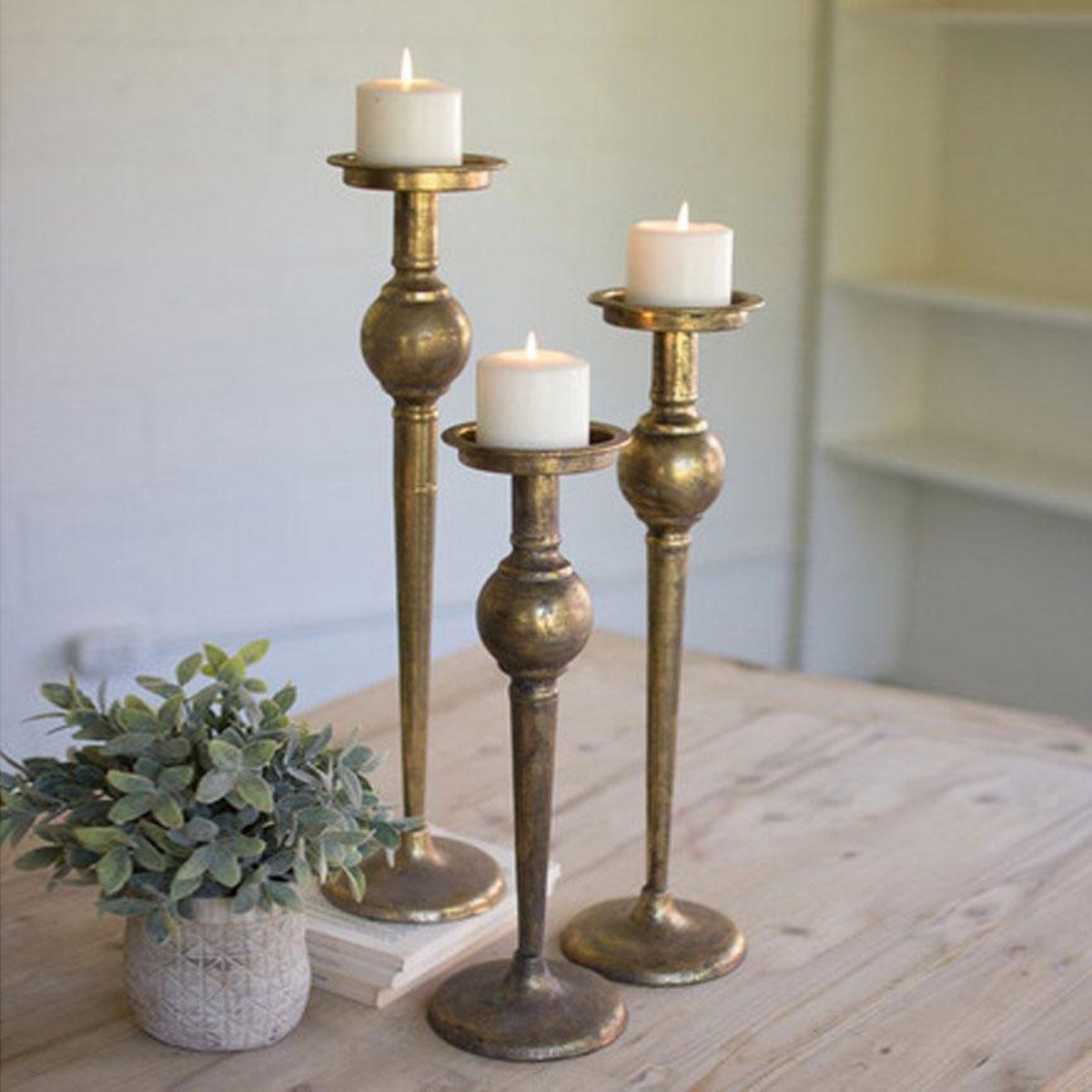 https://www.ironaccents.com/cdn/shop/products/brass-candle-holders-set-3-kalalou-lighting_1200x.jpg?v=1613760022